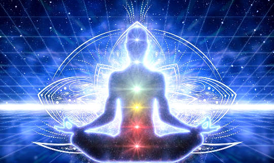 a person in meditation with lit up chakras and energy lines around the body